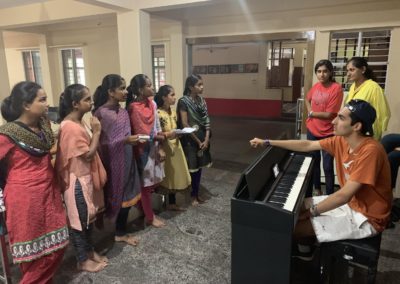 Youth Ambassador teaching girls to sing | SDIE